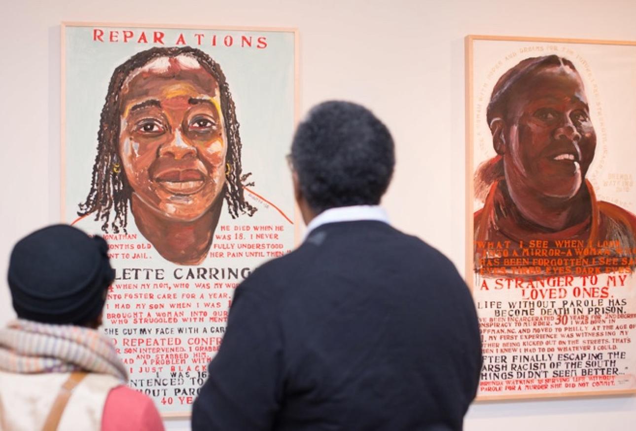 2 Individuals starring at artwork that is part of an exhibit